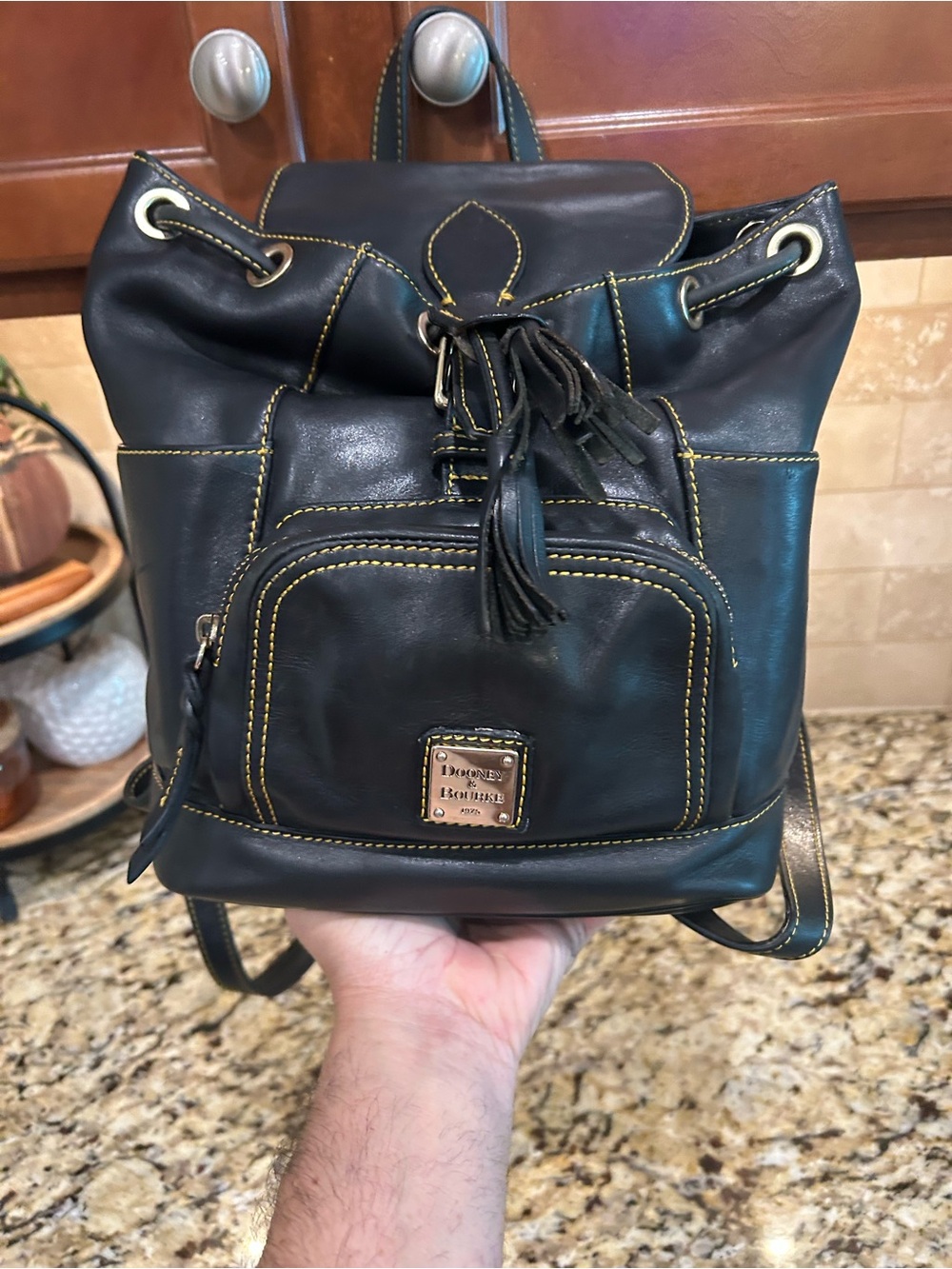 Dooney & Bourke Black Leather Drawstring Backpack with Yellow Stitching